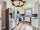 Updated kitchen featuring stainless steel appliances, grey backsplash, granite countertops, and ample cabinet space at 10736 Logan Ct, Northglenn, CO 80233