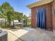 Cozy backyard patio with a grill, table, chairs, and a partial brick wall with a blue curtain at 10736 Logan Ct, Northglenn, CO 80233