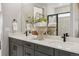 Luxurious bathroom featuring double sinks, quartz countertop and glass enclosed shower at 17075 W 92Nd Loop, Arvada, CO 80007