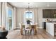 A dining area with sliding doors, views, hardwood floors, modern lighting and neutral colors create a welcoming atmosphere at 17075 W 92Nd Loop, Arvada, CO 80007