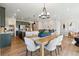 A combination kitchen and dining area that includes modern lighting, new cabinets, countertops and stainless steel appliances at 17075 W 92Nd Loop, Arvada, CO 80007