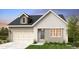 Charming home with a two-car garage, stone and siding exterior, manicured landscaping, and a welcoming entryway at 17075 W 92Nd Loop, Arvada, CO 80007