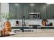 The kitchen boasts sleek, modern cabinetry, stainless steel appliances, and stylish fixtures, creating a chef's dream space at 17075 W 92Nd Loop, Arvada, CO 80007