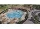 Aerial view of a resort-style community pool with lounge chairs and manicured landscaping at 17075 W 92Nd Loop, Arvada, CO 80007