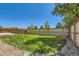 Spacious backyard with lush green grass, wood fencing, and a rock garden landscape feature at 10460 Ketchwood Ct, Highlands Ranch, CO 80130