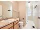 Powder bathroom with a single vanity sink, toilet, and coat hooks at 10460 Ketchwood Ct, Highlands Ranch, CO 80130