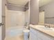 Well-lit bathroom featuring a bathtub with shower, a neutral vanity, and tiled flooring at 10460 Ketchwood Ct, Highlands Ranch, CO 80130