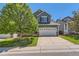 Charming two-story home features a large front yard, driveway, and a spacious two-car garage at 10460 Ketchwood Ct, Highlands Ranch, CO 80130