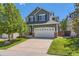 Charming two-story home features a large front yard and a spacious two-car garage at 10460 Ketchwood Ct, Highlands Ranch, CO 80130