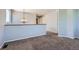 Bright second floor hallway with neutral paint, carpet flooring, wood railing and modern lighting at 10460 Ketchwood Ct, Highlands Ranch, CO 80130
