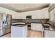 Modern kitchen features white cabinetry, mosaic backsplash, granite countertops, and stainless steel appliances at 10460 Ketchwood Ct, Highlands Ranch, CO 80130