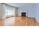 Bright living room boasts hardwood floors, fireplace, and large windows at 10460 Ketchwood Ct, Highlands Ranch, CO 80130