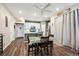 Bright dining area featuring wood floors, a table with seating for four, and views into the kitchen at 765 N Shawnee St, Aurora, CO 80018