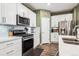 Stylish kitchen featuring stainless steel appliances, white cabinets, and a gas range at 765 N Shawnee St, Aurora, CO 80018