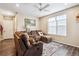 Relaxing living room with a cozy sectional sofa, a ceiling fan, and natural light from a large window at 765 N Shawnee St, Aurora, CO 80018