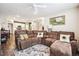 Open concept living room with a large sectional sofa, ceiling fan, and view into the kitchen at 765 N Shawnee St, Aurora, CO 80018