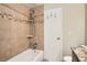 Bathroom features a tiled shower with decorative border and convenient shelving at 865 S Quebec St # 104B, Denver, CO 80247