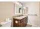 Bathroom with granite countertop vanity, decorative mirror, and tiled flooring at 865 S Quebec St # 104B, Denver, CO 80247
