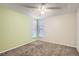 Cozy bedroom with large windows, plush carpeting, and modern ceiling fan at 865 S Quebec St # 104B, Denver, CO 80247