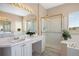 Lovely bathroom features a shower, large mirror with vanity lighting and dual vanities and sinks at 11558 Pine Hill Way, Parker, CO 80138