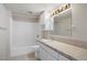 All-white bathroom with shower-tub combo, vanity, and bright overhead lighting at 11558 Pine Hill Way, Parker, CO 80138
