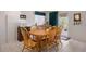 Cozy dining room with natural wood table and chairs, tiled flooring and a view of the outside at 11558 Pine Hill Way, Parker, CO 80138