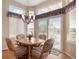 Bright dining area featuring hardwood floors, natural light, and a door leading to an outdoor deck at 11558 Pine Hill Way, Parker, CO 80138