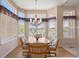 Bright dining area with a chandelier, wood floors, large windows, and views of the outdoor scenery at 11558 Pine Hill Way, Parker, CO 80138
