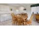A cozy kitchen with white appliances, cabinets and dining table, creating an inviting space for meals at 11558 Pine Hill Way, Parker, CO 80138