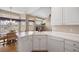 Bright kitchen featuring white cabinets, stainless steel appliances, light countertops, and wood flooring at 11558 Pine Hill Way, Parker, CO 80138