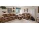 Inviting living room with two couches, a side table, an ottoman, and nature-themed decor at 11558 Pine Hill Way, Parker, CO 80138