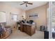 Cozy home office with a large, ornate wooden desk, a ceiling fan, and natural light from the window at 11558 Pine Hill Way, Parker, CO 80138
