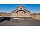 Barn with three garage doors, stone accents, and a basketball hoop, set against a rural landscape at 2785 Bears Den Dr, Sedalia, CO 80135