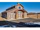 Exterior view of a barn with multiple garage doors and a paved driveway in a rural setting at 2785 Bears Den Dr, Sedalia, CO 80135