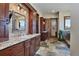 Spacious bathroom features double sinks, stone accents, granite counters, and a rustic wood sliding door at 2785 Bears Den Dr, Sedalia, CO 80135