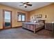 Rustic bedroom showcasing a bed with wooden frame, and a door to the outside at 2785 Bears Den Dr, Sedalia, CO 80135