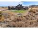 Expansive rustic home featuring a well-manicured lawn and surrounding natural landscape at 2785 Bears Den Dr, Sedalia, CO 80135