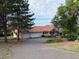 Charming home with a spacious driveway and attached two-car garage, framed by mature trees and a well-manicured lawn at 17852 E Long Ave, Centennial, CO 80016