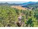 Expansive views surround this secluded home in a lush valley with distant mountains at 24929 N Mountain Park Dr, Evergreen, CO 80439