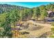 Aerial view of property showcasing the house and surrounding landscape with mature trees at 24929 N Mountain Park Dr, Evergreen, CO 80439