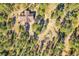 Overhead shot showing a house with a circular driveway surrounded by lush trees at 24929 N Mountain Park Dr, Evergreen, CO 80439