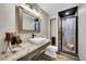 Chic bathroom featuring a stylish sink, glass-enclosed shower, and sleek finishes at 24929 N Mountain Park Dr, Evergreen, CO 80439