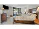 Spacious bedroom with a large bed, a TV, and access to an outdoor balcony overlooking nature at 24929 N Mountain Park Dr, Evergreen, CO 80439