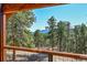 Stunning mountain views from the wood deck with metal cable railing and fresh air at 24929 N Mountain Park Dr, Evergreen, CO 80439