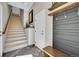 Inviting entryway with staircase, coat rack, and neutral color palette at 24929 N Mountain Park Dr, Evergreen, CO 80439