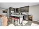 Modern kitchen featuring dark cabinets, granite countertops, a spacious island and seating at 24929 N Mountain Park Dr, Evergreen, CO 80439
