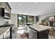 Open kitchen with large island, stainless appliances, and sliding glass doors to the outdoor deck at 24929 N Mountain Park Dr, Evergreen, CO 80439