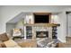 Cozy living room with a stone fireplace and rustic decor for a mountain cabin ambiance at 24929 N Mountain Park Dr, Evergreen, CO 80439