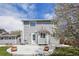 Backyard view showcasing the home's exterior, a patio area, and blossoming tree at 882 W 96Th Ave, Thornton, CO 80260