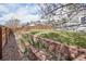 Landscaped backyard featuring a brick-lined garden bed and a wooden fence at 882 W 96Th Ave, Thornton, CO 80260